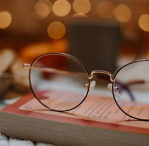 This image shows blue light night sky and book that helps eye vision and helps sleep at night. These blue light glasses help your life by helping eye soreness headache and are good for gaming.